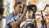 Medium shot woman repairing bicycle